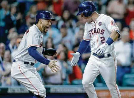  ?? Michael Ciaglo / Staff photograph­er ?? George Springer, left, appears even more excited about Alex Bregman’s third-inning homer Wednesday night than the man himself.