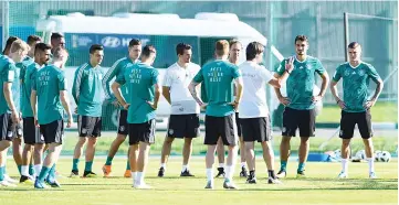  ??  ?? Germany’s coach Joachim Loew (C) speaks with his players as he leads a training session in Vatutinki, near Moscow, on June 15, 2018, as part of the Russia 2018 World Cup football tournament.