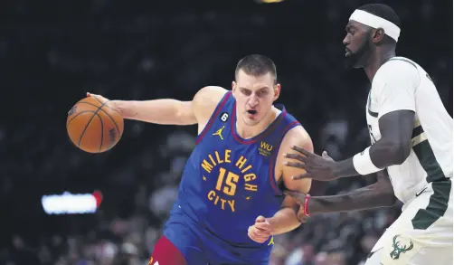  ?? ?? Nuggets center Nikola Jokic (L) drives at Bucks forward Bobby Portis during an NBA game, Denver, Colorado, U.S., March 25, 2023.