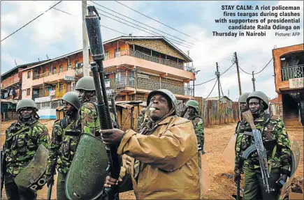  ?? Picture: AFP ?? STAY CALM: A riot policeman fires teargas during clashes with supporters of presidenti­al candidate Raila Odinga on Thursday in Nairobi