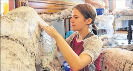  ?? MILLICENT MCKAY/JOURNAL PIONEER ?? Jessica Noonan and Olivia Shaw, background, work on building parts of a giant papier-mâché lobster for the Culture Summerside float for the Summerside Lobster Carnival Parade.