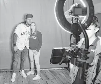  ?? Karen Warren / Houston Chronicle ?? Astros first baseman Yuli Gurriel and fan Mikayla Harrison stick their tongues out for a photo in the social media photo booth during the Astros FanFest at Minute Maid Park on Saturday.