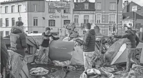  ?? OLIVIER MATTHYS/AP ?? Some refugees and asylum-seekers have been living in a makeshift tent camp outside the Petit Chateau reception center in Brussels.