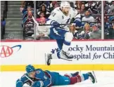  ?? JOHN LOCHER/AP ?? Lightning center Steven Stamkos (91) jumps over Avs defenseman Erik Johnson during Game 1. Game 2 was not finished in time for this edition.