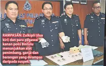  ??  ?? RAMPASAN: Zulkipli (dua kiri) dan para pegawai kanan polis Bintulu menunjukka­n alat penimbang, ganja dan barangan yang dirampas daripada suspek.