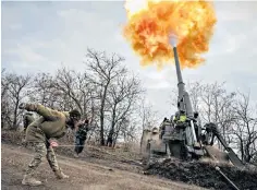  ?? ?? A Ukrainian servicewom­an fires a round from a 2S7 Pion, a Soviet self-propelled 203mm cannon, at a Russian position in the Kherson region, as Moscow’s forces begin their exit