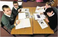  ??  ?? From left, Callum Kinnaird, Keiran McNaught, Harvie MacDonald and Maykl Fleming at Rosebank Primary School in Nairn design their news pages