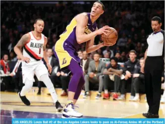  ??  ?? LOS ANGELES: Lonzo Ball #2 of the Los Angeles Lakers looks to pass as Al-Farouq Aminu #8 of the Portland Trail Blazers defends during the first half of a game at Staples Center on Saturday. — AFP