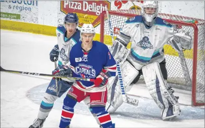  ?? OLIVIER CHIASSON PHOTO ?? Edmundston Blizzard defenceman Keenan Gillis looks to prevent Summerside Western Capitals forward Austin Taylor from screening goaltender Francis Asselin during Game 2 of the best-of-seven Eastlink North Division final series in the MHL (Maritime...