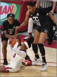  ?? (NWA Democrat-Gazette/J.T. Wampler) ?? Makayla Daniels of Arkansas struggles for the ball with Texas A&M’s Aaliyah Wilson (left) and N’dea Jones on Sunday at Walton Arena in Fayettevil­le. Daniels had 16 points in Arkansas’ 74-73 loss.