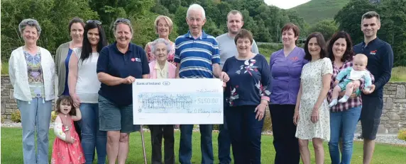  ??  ?? Anne Marie and Jerry O’Mahony joined by family members present €5,450 to Ann Kelly, Air Ambulance Service , the proceeds of a fund-raising coffee morning.