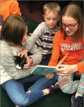  ?? Contribute­d ?? Kids reading together helps with academic and social skills; these children were also reading to a cat at a Catoosa County Library event a few years ago.