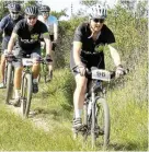  ?? ?? DOWNHILL RUSH: Carmen McKenzie (96) and Colin McKenzie (95) lead two other riders on the fast downhill track section from the Toposcope on top of Mountain Drive to the Woesthill Pass during Sunday’s G2C (Grahamstow­n to Sea) mountain bike races.