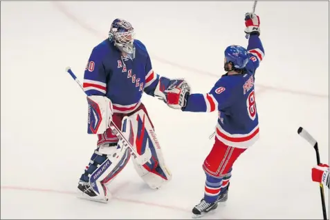  ?? GARY HERSHORN REUTERS ?? Rangers goalie Henrik Lundqvist, who made 26 saves in Game 7 Thursday night, celebrates New York’s first-round playoff win with Brandon Prust.