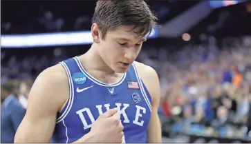  ?? Nati Harnik / AP ?? Duke’s Grayson Allen walks off the court after Sunday’s regional final game against Kansas in the NCAA men’s college basketball tournament when his final buzzer-beating attempt to win the game in overtime failed to go through.