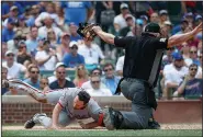  ?? Associated Press ?? Safe: Washington Nationals infielder Daniel Murphy, left, scores against the Chicago Cubs during the second inning of a baseball game Friday in Chicago.