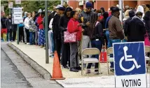  ?? STEVE SCHAEFER / SPECIAL TO THE AJC ?? People wait in a long line to vote on Oct. 27 at the Cobb County Board of Elections and Registrati­on office in Marietta.