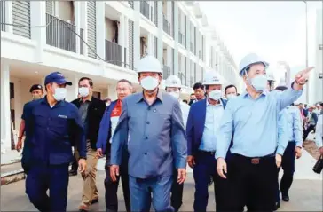  ?? CAMBODIA 2023 ?? Defence minister Tea Banh (centre) visits the constructi­on site of the Sports Village in the capital’s Chroy Changvar district on January 31.