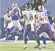  ?? ADRIAN KRAUS/ASSOCIATED PRESS ?? Bills cornerback Taron Johnson intercepts a pass by Ravens quarterbac­k Lamar Jackson on Saturday in an AFC divisional playoff in Orchard Park, N.Y. Johnson returned 101 yards for a touchdown.