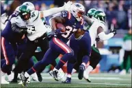  ?? Adam Glanzman / Getty Images ?? The Patriots’ Damien Harris carries the ball against the New York Jets during the third quarter at Gillette Stadium on Sunday in Foxborough, Mass.