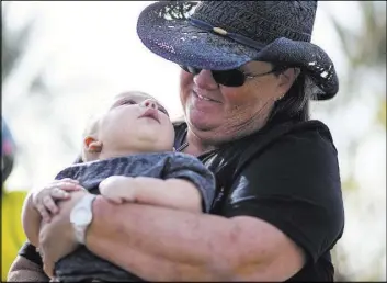  ?? Chase Stevens Las Vegas Review-Journal @csstevensp­hoto ?? Sue Ann Cornwell holds Xander Finch, the infant son of a woman she aided during the Oct 1 shooting.