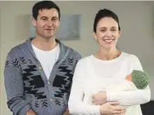  ?? AP ?? Jacinda Ardern, with her partner Clarke Gayford, holds their newly born baby girl, Neve, at Auckland Hospital .