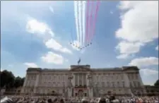  ?? KIRSTY WIGGLESWOR­TH — THE ASSOCIATED PRESS ?? The Red Arrows fly past as Britain’s Royals watch from the balcony of Buckingham Palace, after the annual Trooping the Colour Ceremony in London, Saturday.