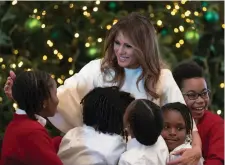  ??  ?? US First Lady Melania Trump is greeted by school children as she arrives to meet them in the East Room after the Christmas decoration­s went up at the White House in Washington DC yesterday. Photo: Carolyn Kaster/AP