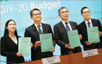  ?? EDMOND TANG / CHINA DAILY ?? Financial Secretary Paul Chan Mo-po (center left) and other officials display the 2019-20 Budget during a press conference on Wednesday.