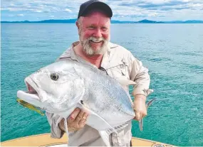  ?? ?? Bucket list fish: Jim Muirhead mustered fishing skills he didn’t know he owned to land this solid GT on light barra tackle.