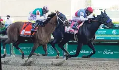  ?? Darron Cummings / Associated Press ?? John Valazquez, right, rides Medina Spirit ahead of Florent Geroux aboard Mandaloun to win the Kentucky Derby on Saturday at Churchill Downs in Louisville, Ky.