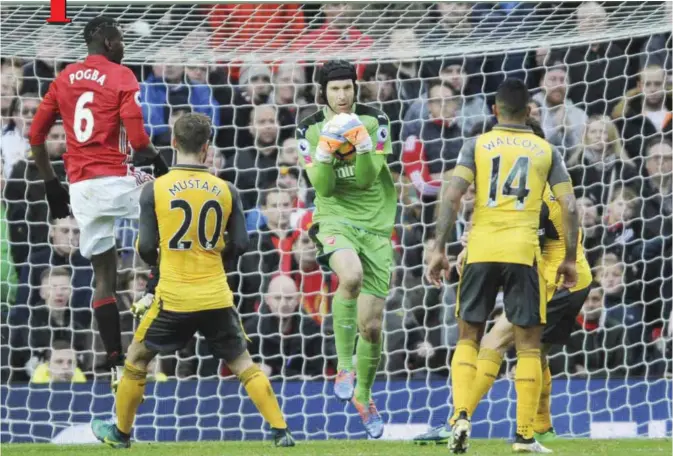  ??  ?? MANCHESTER: Arsenal’s Petr Cech, centre, saves a shoot during the English Premier League soccer match between Manchester United and Arsenal at Old Trafford in Manchester, England, yesterday. —AP