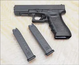  ?? Rich Pedroncell­i Associated Press ?? A FEDERAL judge Thursday blocked a state law banning possession of magazines that hold more than 10 rounds. Above, a handgun with 10- and 15-shot magazines.