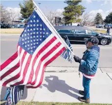  ?? DAVID ZALUBOWSKI/AP ?? Joe Duran, of Thornton, Colo., salutes Tuesday as a hearse carries the casket of Officer Eric Talley.