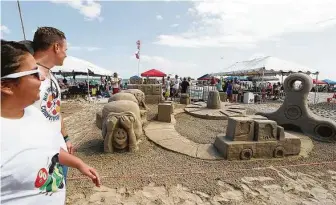  ?? Kelsey Walling / The Galveston County Daily News ?? The annual AIA Sandcastle Competitio­n at East Beach draws big crowds to Galveston.