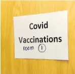  ??  ?? ●● Signs for Covid vaccinatio­ns are uplifting