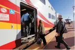  ?? GABRIELA CAMPOS NEW MEXICAN FILE PHOTO ?? Commuters board a Rail Runner train last year at the South Capitol station in Santa Fe.