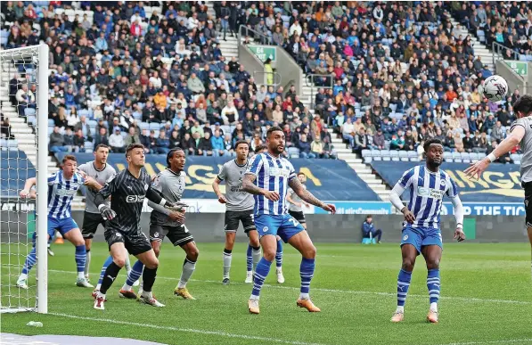  ?? ?? Rovers defender Elkan Baggott heads the ball towards the Wigan goal during Saturday’s League One game at the DW Stadium