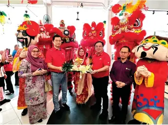  ?? ?? Fatimah (centre) joins the sponsors of the Chinese New Year event at the CSSC, in a photo-call with the lion dance performers.