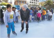  ??  ?? Top, Ricardo Casoverde, 10, is escorted around the ice at the Union Square rink by Thomas Schrader. Above, Jason Berrera-Perez, 10, gets tips from Olympian Brian Boitano on the opening day at Union Square.