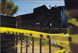  ?? PHOTO BY DYLAN BOUSCHER ?? Police tape surrounds the remains of a home destroyed in a two-alarm fire that killed a father and daughter on the 9600 block of Stearns Avenue in East Oakland on Saturday.