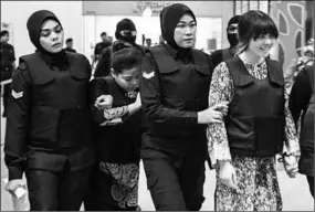  ??  ?? Indonesian Siti Aisyah, left, and Vietnamese Doan Thi Huong, right, are being escorted into the court room for the murder trial of Kim Jong-nam, the half-brother of North Korea’s leader. (Photo: The Japan Times)