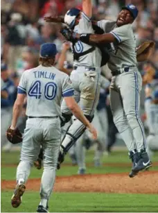  ?? HANS DERYK/THE CANADIAN PRESS FILE PHOTO ?? Joe Carter, right, hugs Pat Borders after pitcher Mike Timlin got the final out on Oct. 24, 1992, to seal the Jays’ first World Series win.