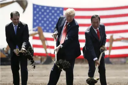  ?? Photograph: Evan Vucci/AP ?? Trump in June 2018 breaks ground for a new Foxconn factory with the then governor, Scott Walker, and the Foxconn chairman, Terry Gou.