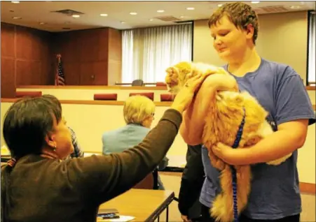  ?? COURTESY OF ANIMAL RESCUE LEAGUE ?? Animal Rescue League volunteer Timothy Bauder, 14, has received a Certificat­e of Appreciati­on from the Department of Education Profession­al Associatio­n. Pictured: Timothy shows off his adopted cat Sunshine.