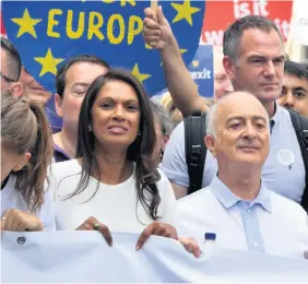  ??  ?? Pro-EU campaigner Gina Miller and Tony Robinson join with crowds gather on Pall Mall in central London, during the People’s Vote march