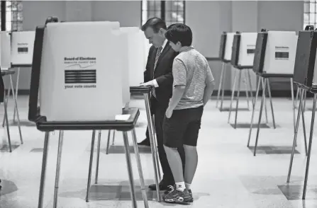  ?? LIZ DUFOUR/CINCINNATI ENQUIRER ?? John Cranley, former Cincinnati mayor and democratic candidate for Ohio governor, votes in the primary Tuesday. He was at the Knox Presbyteri­an Church in Hyde Park with his son, Joseph, 13, and his wife, Dena.