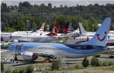  ?? AP FILE ?? STILL GROUNDED: Dozens of grounded Boeing 737 MAX airplanes crowd a parking area next to Boeing Field in Seattle in August. Boeing officials said Saturday they know they have to ‘re-earn’ the trust of the flying public after mistakes leading to two deadly crashes.