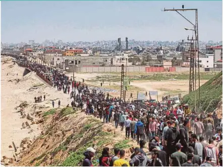  ?? AFP PIC ?? Displaced Palestinia­ns taking the coastal Rashid road to return to Gaza City as they pass through Nuseirat in the central Gaza Strip on Sunday amid the ongoing conflict in the Palestinia­n territory between Israel and Hamas.