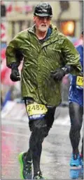  ?? PROVIDED ?? Dennis Moore of New Paltz runs through the raindrops in the recent Boston Marathon.
